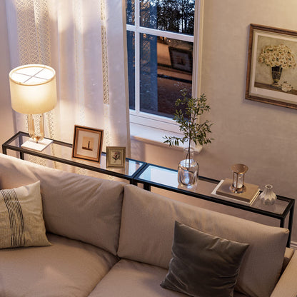 Living room with a beige sofa, lamp, and decorative items on a coffee table.